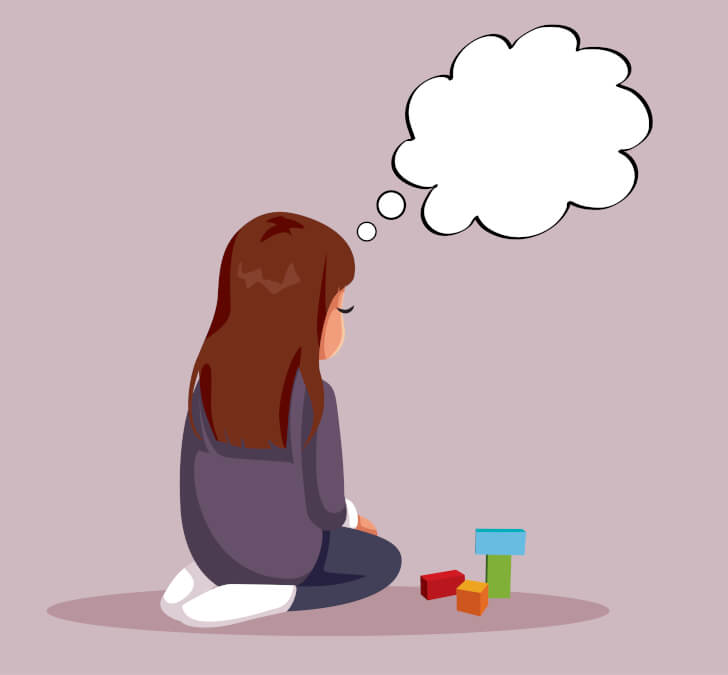 Une jeune fille est agenouillée. À côté d’elle, se tient des blocs de construction. On ne peut qu’apercevoir le profil de son visage. Ses expressions non verbales indiquent qu’elle est triste. Au-dessus de sa tête, se tient un nuage de pensées vide. 